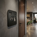Black MDF women’s toilet sign with left arrows for cafés, pubs and restaurants
